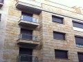 Fachada principal echa con piedra de Burgos,balcones en acero inoxidable y ventanas de pvc.